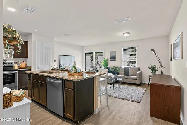 a view of a living room and kitchen area