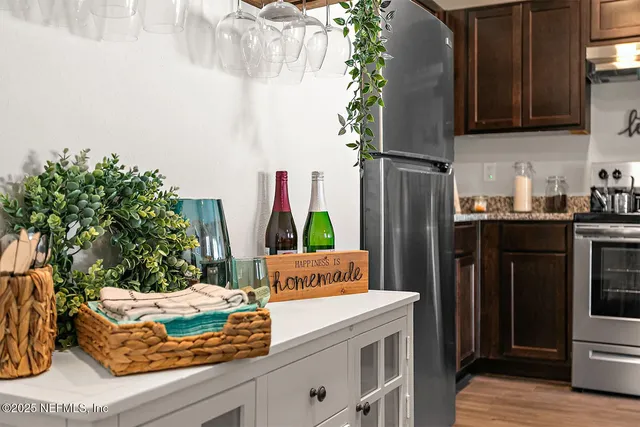 a kitchen with stainless steel appliances kitchen island granite countertop a refrigerator and a stove top oven