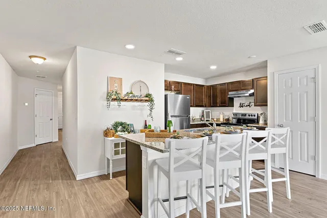 a kitchen with stainless steel appliances kitchen island granite countertop a sink and cabinets