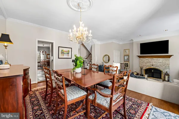 a view of a dining room with furniture and chandelier
