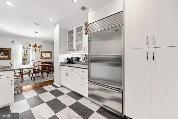 a kitchen with a sink a refrigerator and cabinets