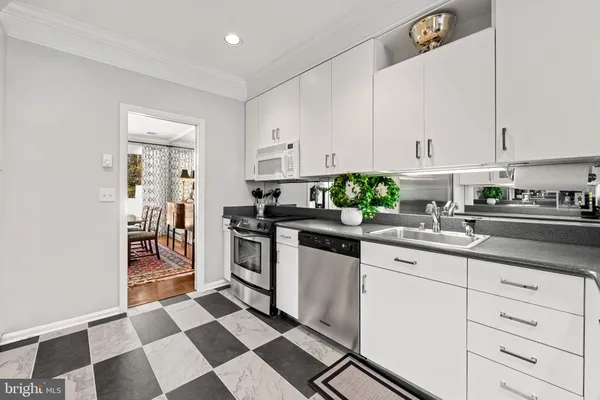 a bathroom with a granite countertop sink a toilet and mirror