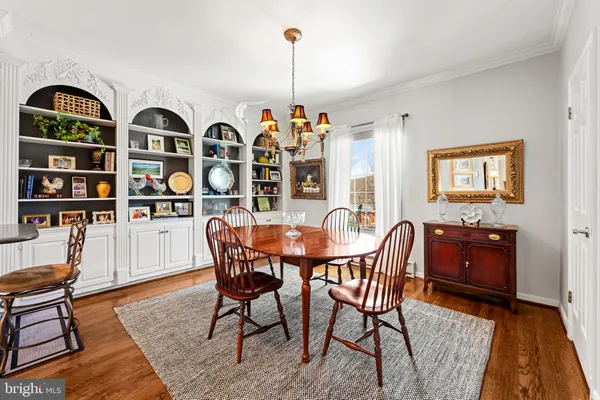 a dining room with furniture and wooden floor