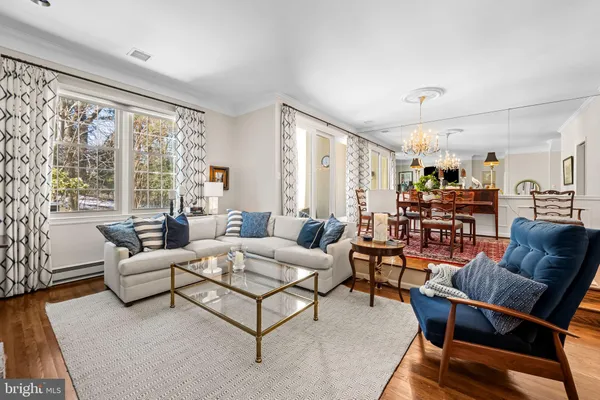 a view of a dining room with furniture and chandelier