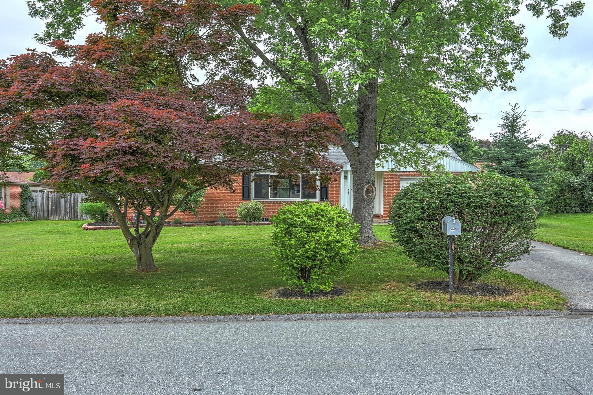 405 Edgehill Road York, PA 17403 - Photo 2 of 30 a front view of a house with a yard and large trees