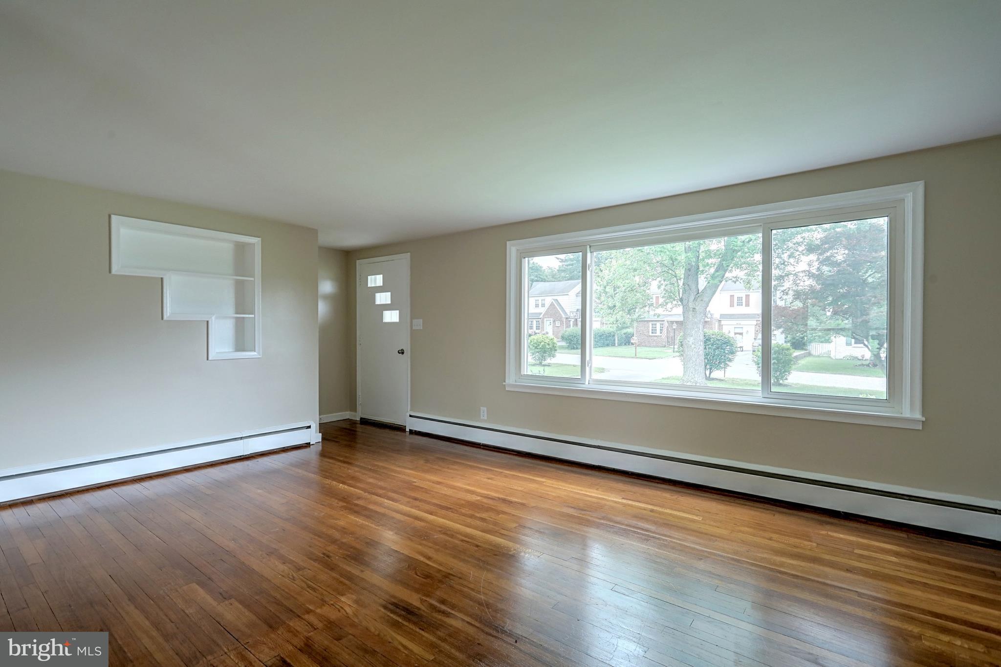 405 Edgehill Road York, PA 17403 - Photo 11 of 30 a view of an empty room with wooden floor and a window