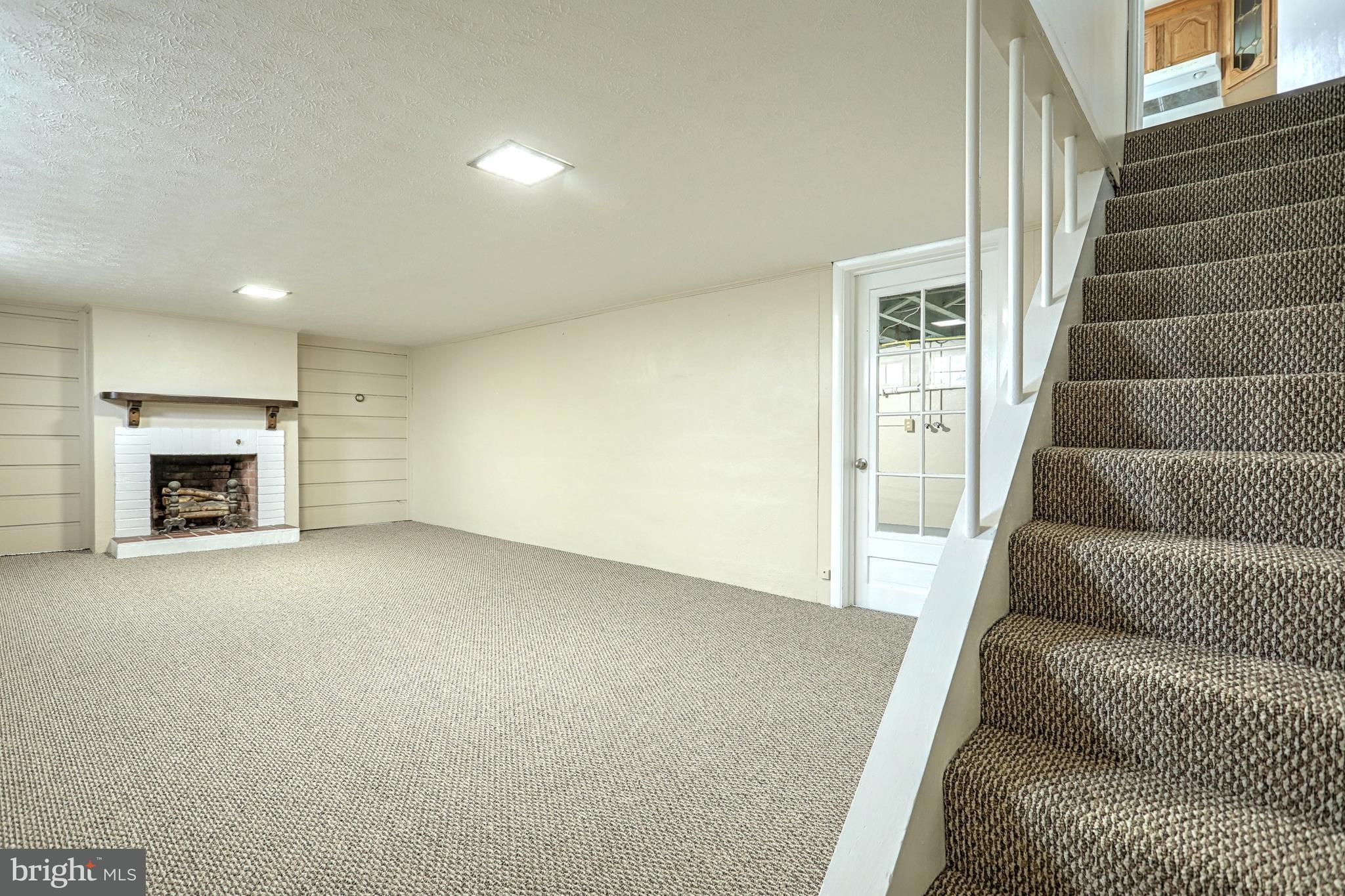 405 Edgehill Road York, PA 17403 - Photo 25 of 30 a view of an empty room with fireplace and stairs