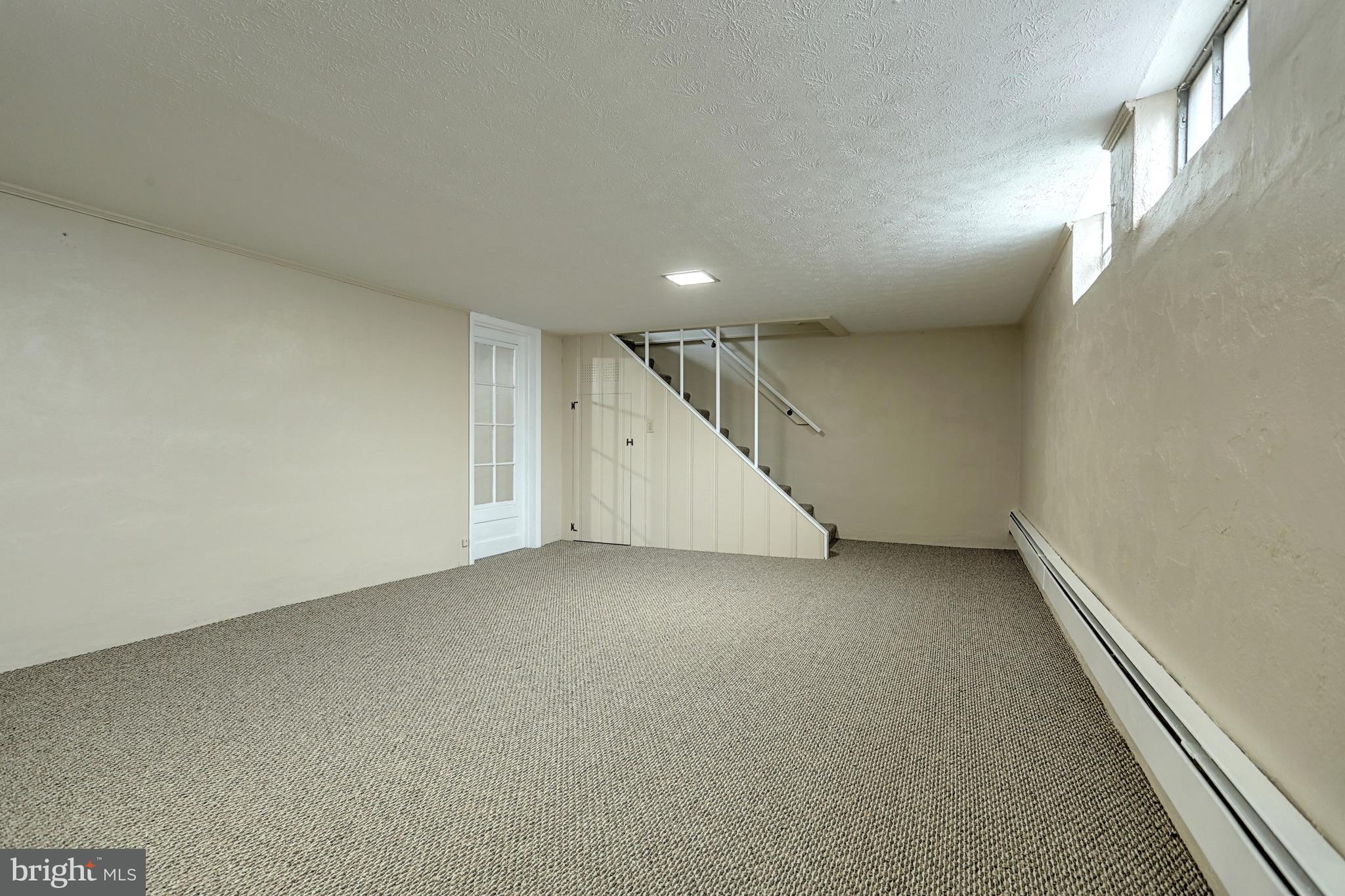 405 Edgehill Road York, PA 17403 - Photo 26 of 30 an empty room with a ceiling fan and stairs