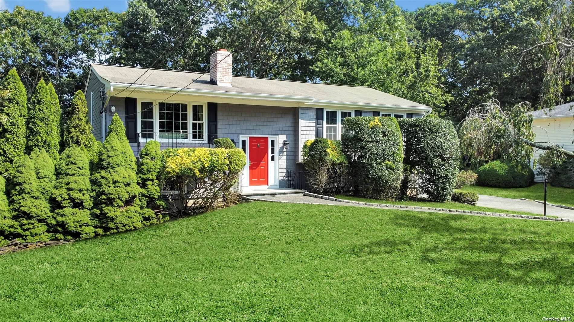 a front view of house with yard and green space