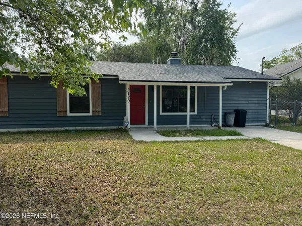 a view of a house with a backyard