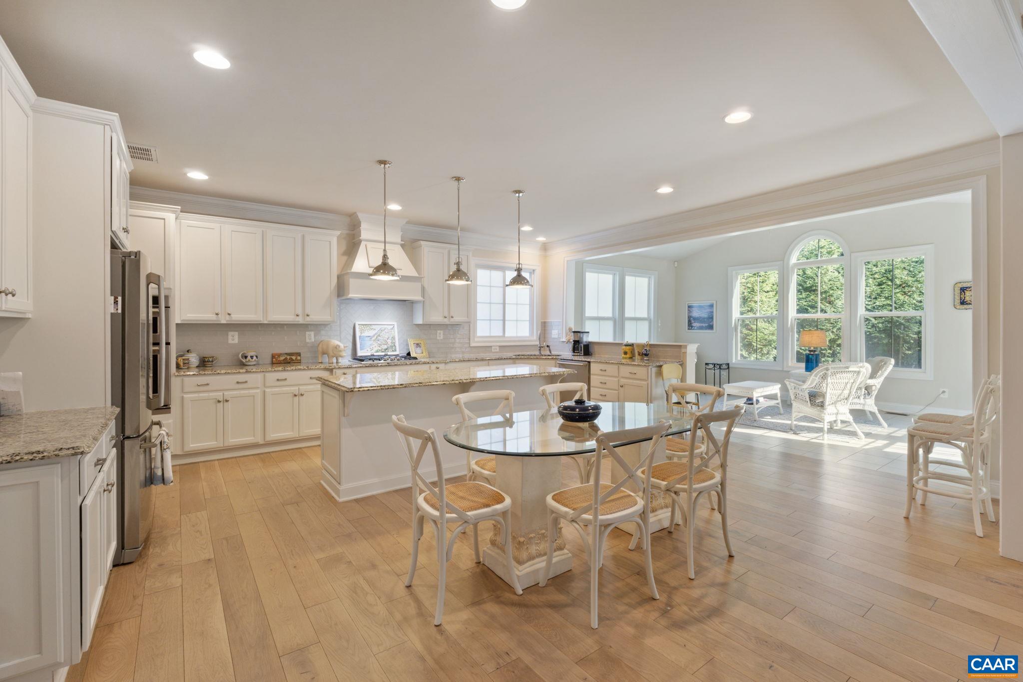 3650 Newbridge Road Keswick, VA 22947 - Photo 20 of 58 a dining room with stainless steel appliances kitchen island granite countertop a dining table chairs and view living room