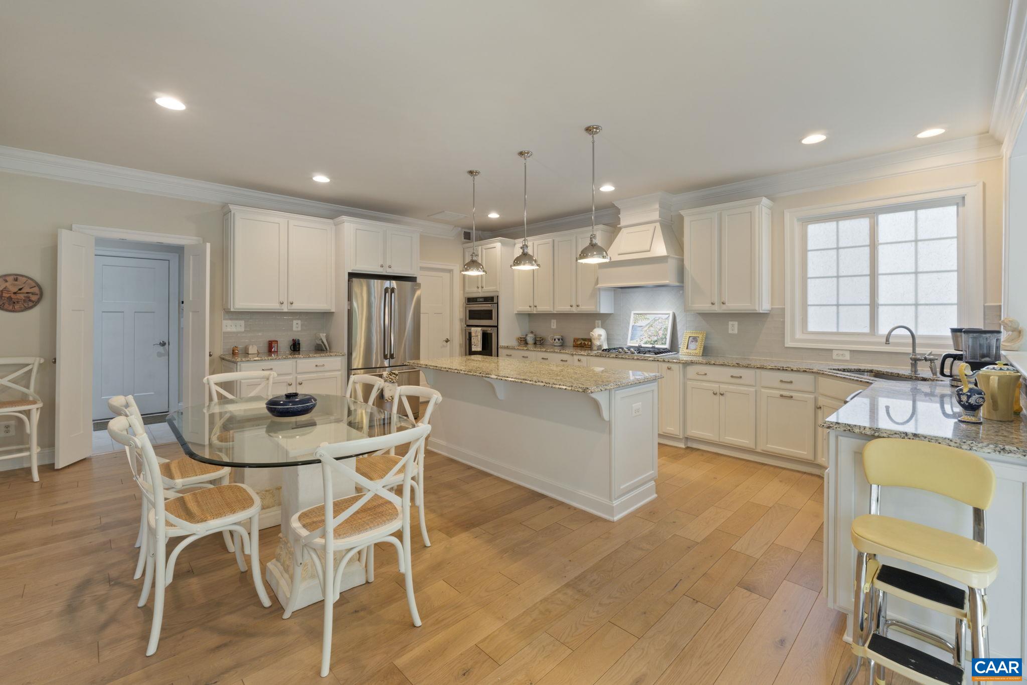 3650 Newbridge Road Keswick, VA 22947 - Photo 23 of 58 a kitchen with a table chairs sink and cabinets