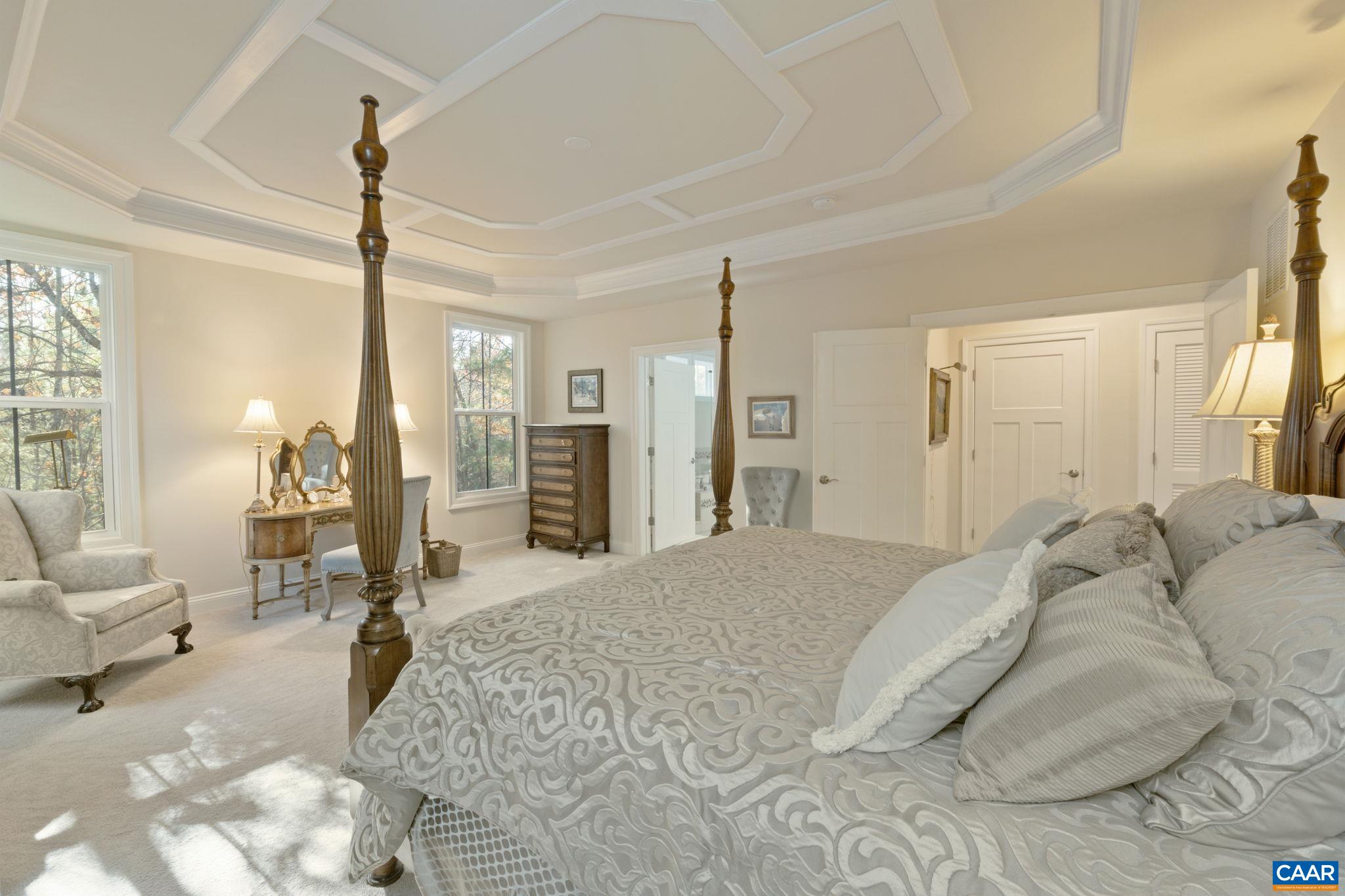 3650 Newbridge Road Keswick, VA 22947 - Photo 35 of 58 a spacious bedroom with a bed a couch and large windows