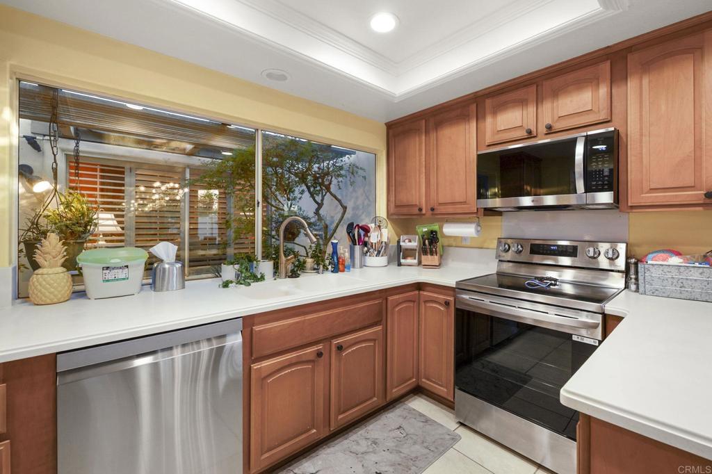 4683 Majorca Way Oceanside, CA 92056 - Photo 16 of 55 a kitchen with stainless steel appliances granite countertop a sink and a stove