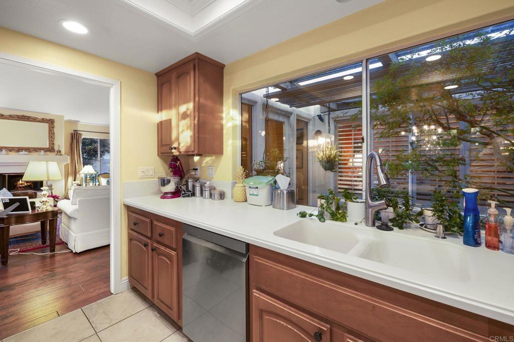 4683 Majorca Way Oceanside, CA 92056 - Photo 17 of 55 a kitchen with a sink and a large mirror