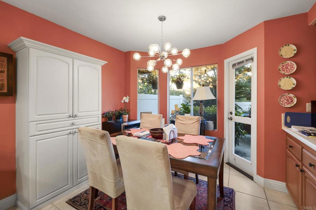4683 Majorca Way Oceanside, CA 92056 - Photo 18 of 55 a living room with furniture a large window and a chandelier