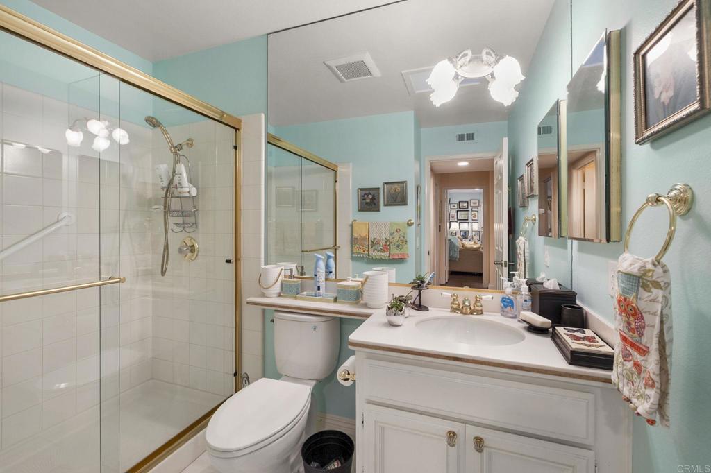 4683 Majorca Way Oceanside, CA 92056 - Photo 24 of 55 a bathroom with a sink a toilet and shower a mirror
