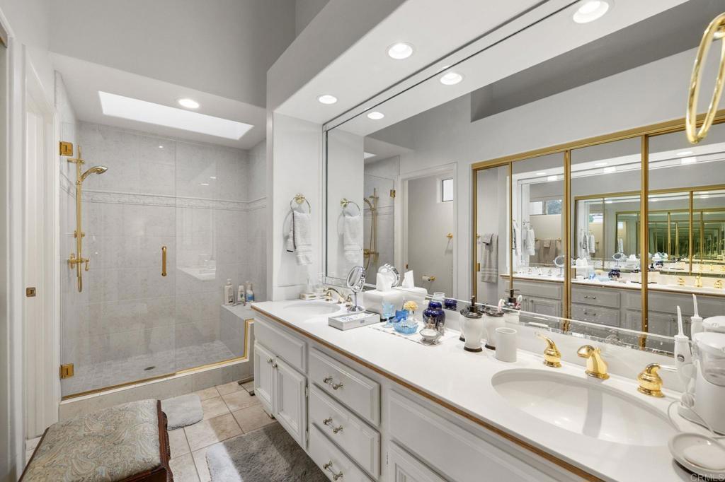 4683 Majorca Way Oceanside, CA 92056 - Photo 27 of 55 a bathroom with double vanity sinks and a shower