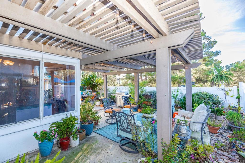 4683 Majorca Way Oceanside, CA 92056 - Photo 29 of 55 a view of a patio with table and chairs potted plants