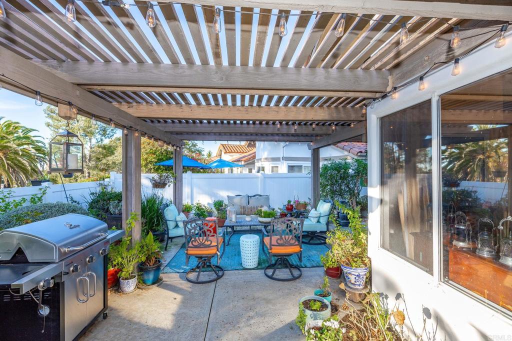 4683 Majorca Way Oceanside, CA 92056 - Photo 31 of 55 a view of a patio with table and chairs and potted plants