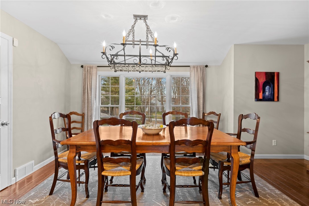 2840 Concord Road Cleveland, OH 44124 - Photo 17 of 35 Dining area with dark hardwood / wood-style flooring and a notable chandelier