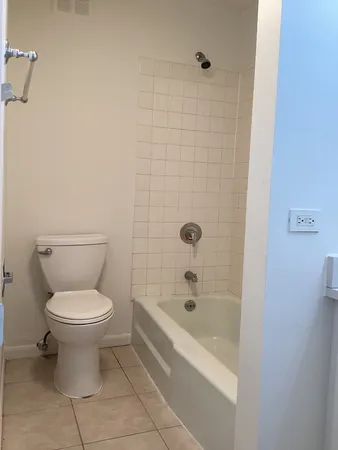 a bathroom with a toilet and a bathtub