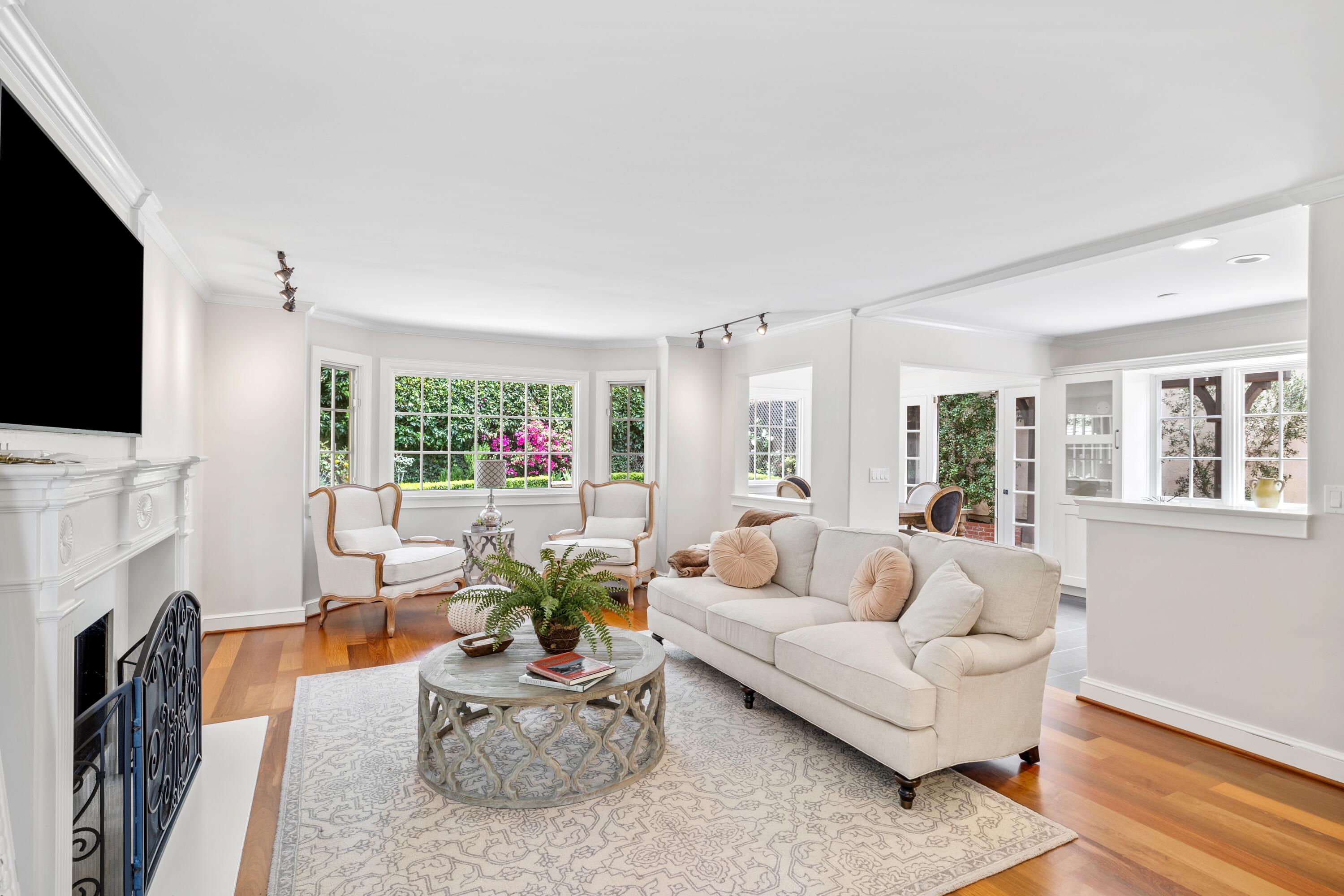 a living room with furniture a fireplace and a flat screen tv