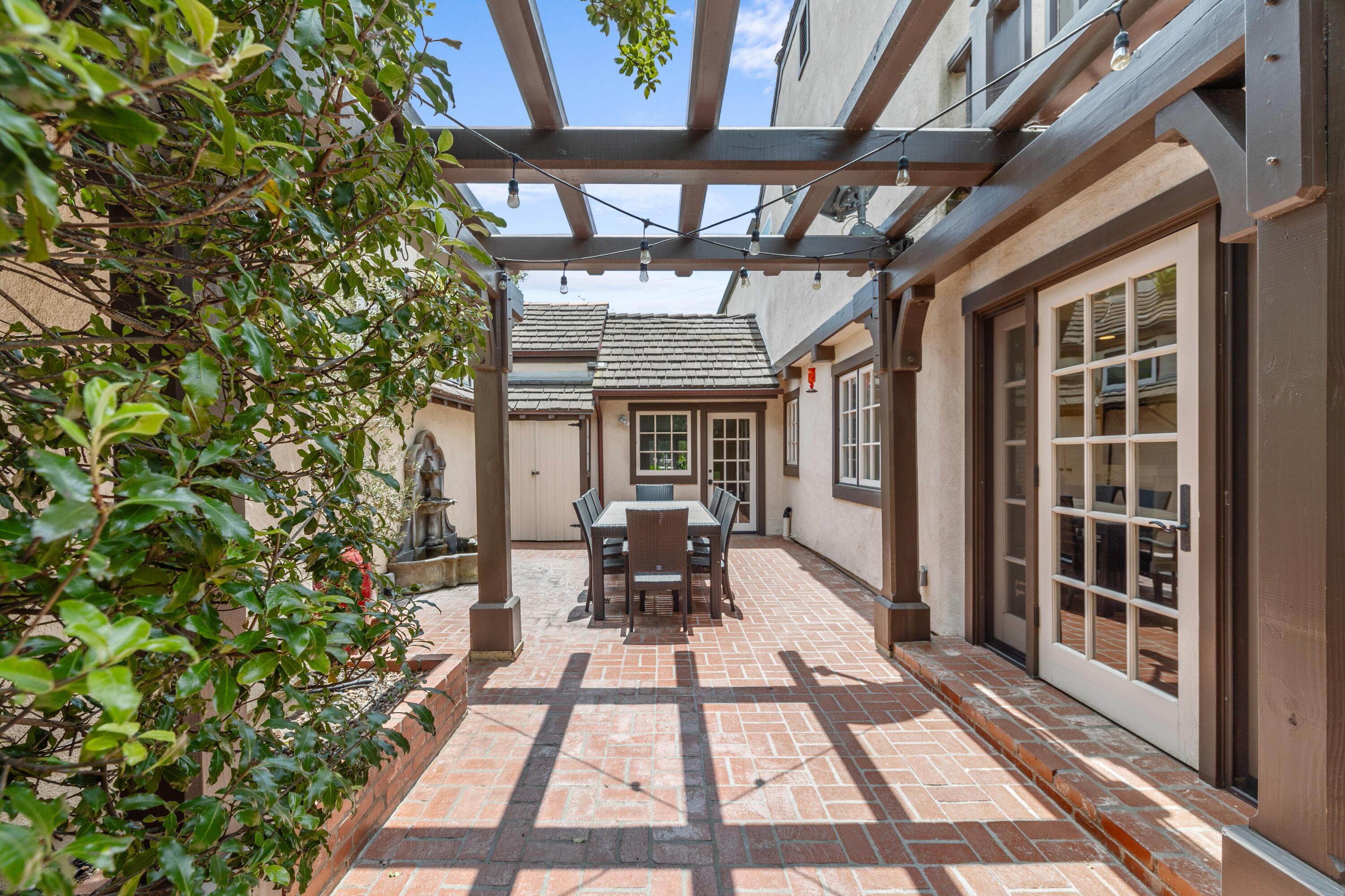 1284 Spring Road Santa Barbara, CA 93108 - Photo 21 of 33 a view of a patio with table and chairs and potted plants
