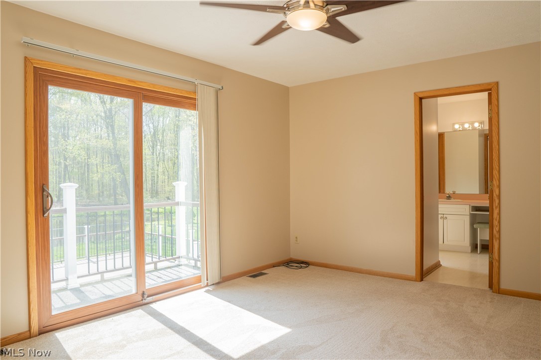 16550 Old State Road Middlefield, OH 44062 - Photo 24 of 35 Master bedroom has a balcony overlooking the backyard with views of the pond and pool.