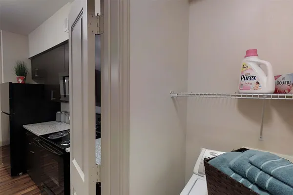 a view of a hallway with workspace and a living room