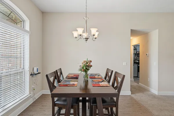 a view of a dining room with furniture and chandelier