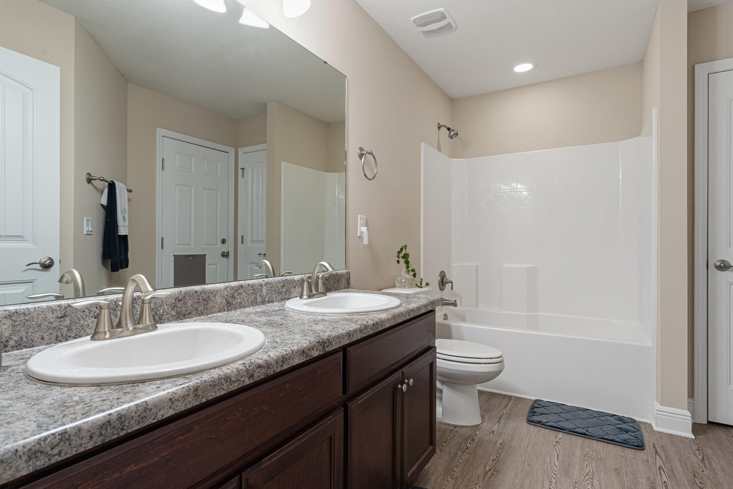 2345 Genevieve Way Crestview, FL 32536 - Photo 18 of 41 a bathroom with a granite countertop sink a toilet a mirror a vanity and shower