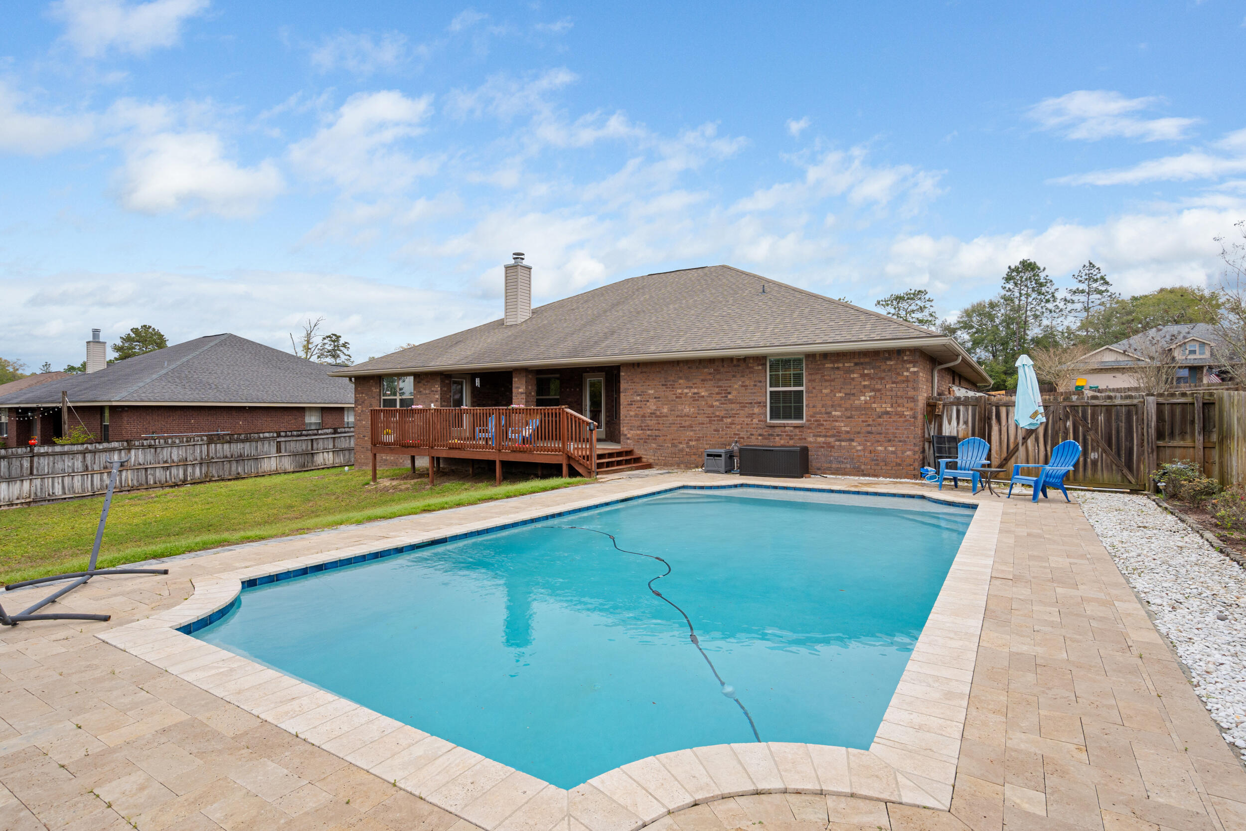 2345 Genevieve Way Crestview, FL 32536 - Photo 2 of 41 a front view of a house with swimming pool having outdoor seating