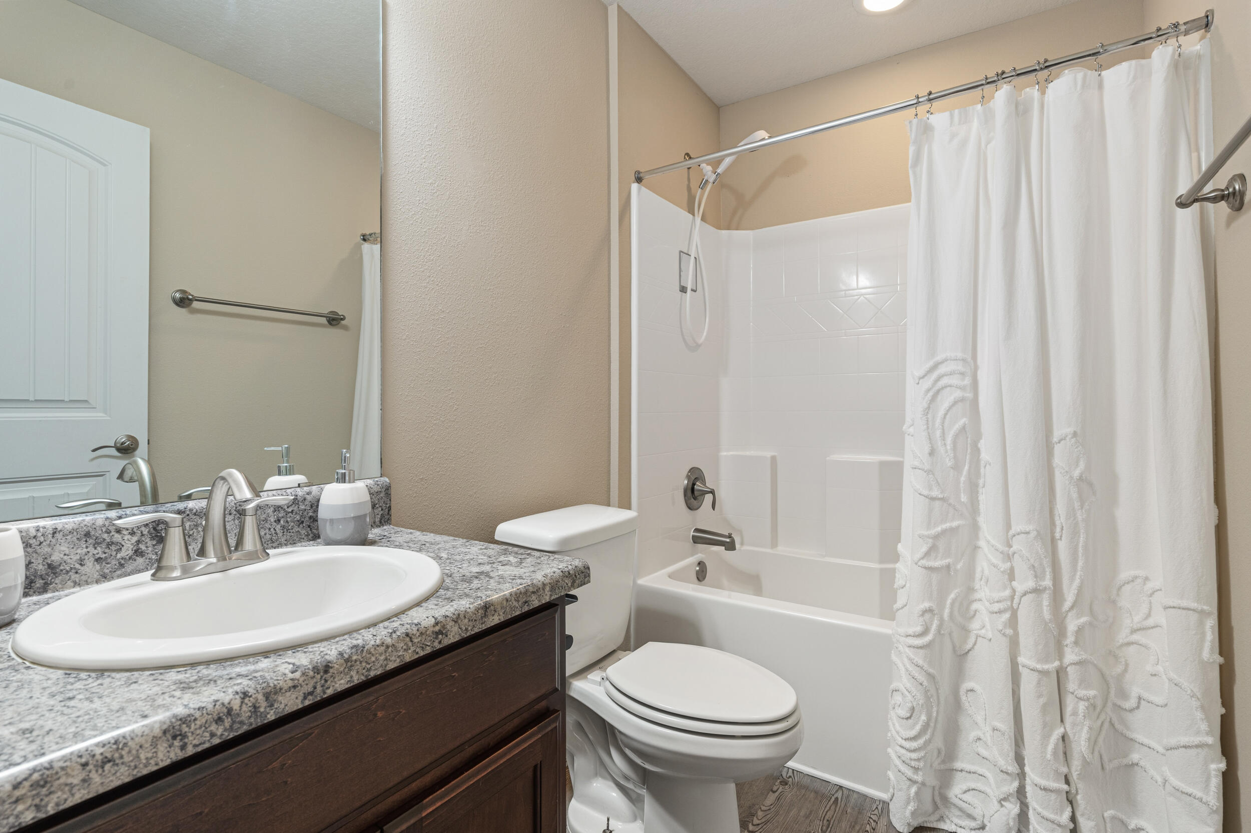 2345 Genevieve Way Crestview, FL 32536 - Photo 21 of 41 a bathroom with a granite countertop sink and a mirror