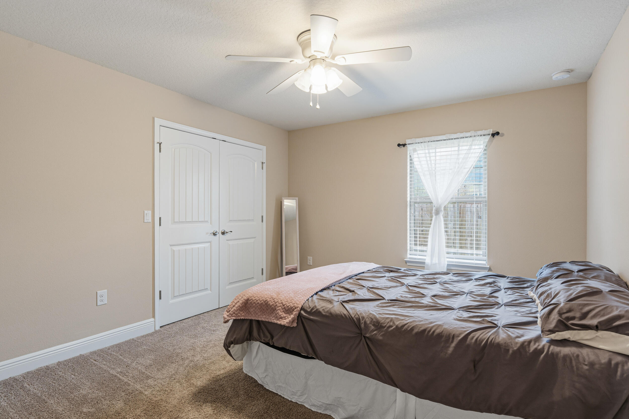 2345 Genevieve Way Crestview, FL 32536 - Photo 22 of 41 a bedroom with a large bed and a chandelier