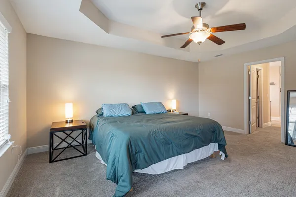 a bedroom with a bed and a chandelier
