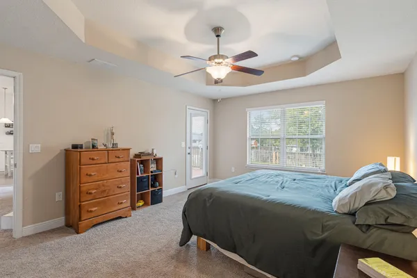 a bedroom with a bed and a chandelier