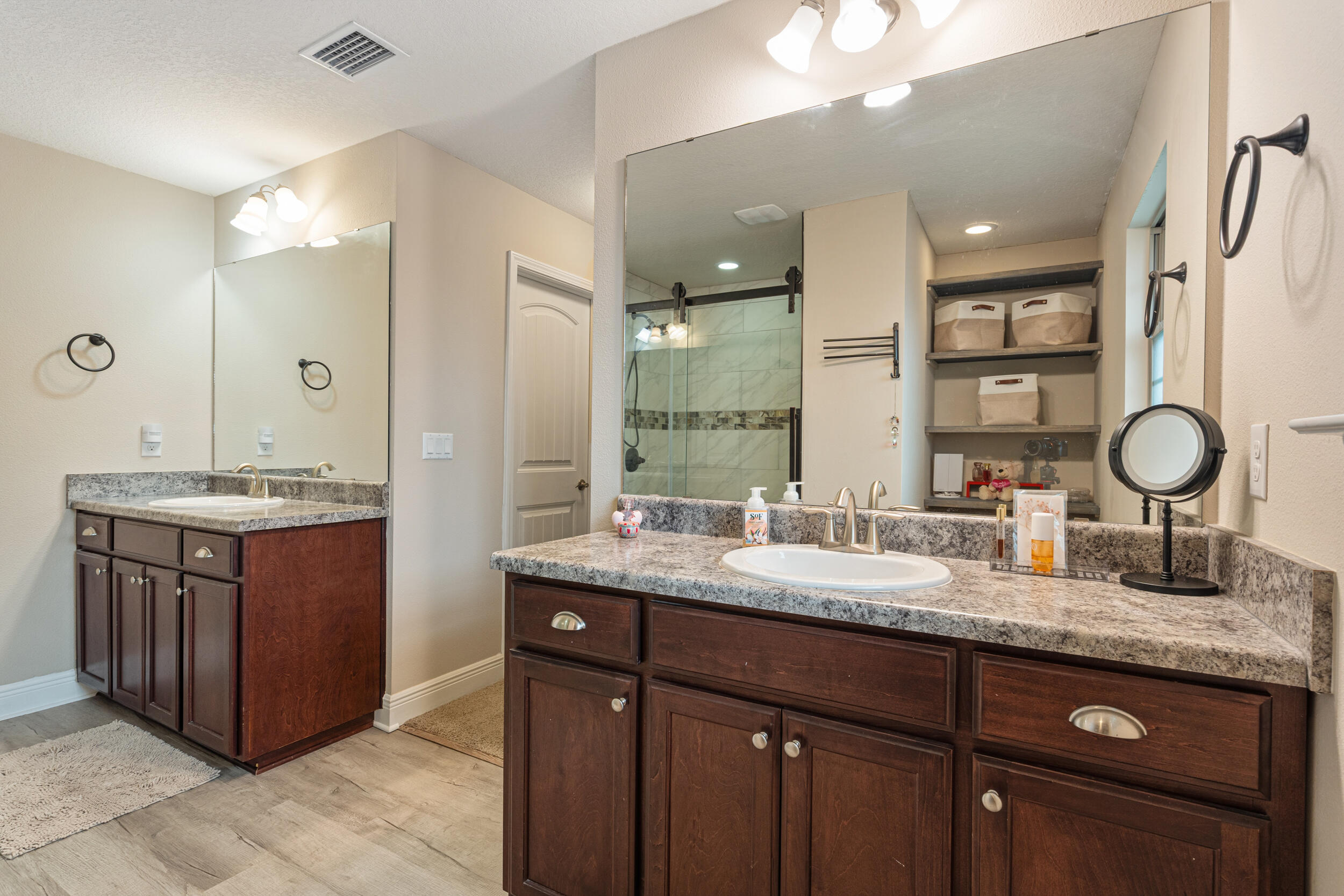 2345 Genevieve Way Crestview, FL 32536 - Photo 27 of 41 a bathroom with a granite countertop sink a toilet a mirror and shower
