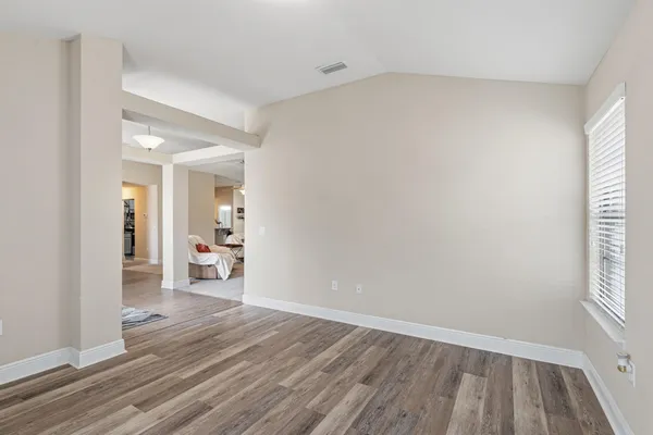wooden floor in an empty room and a window