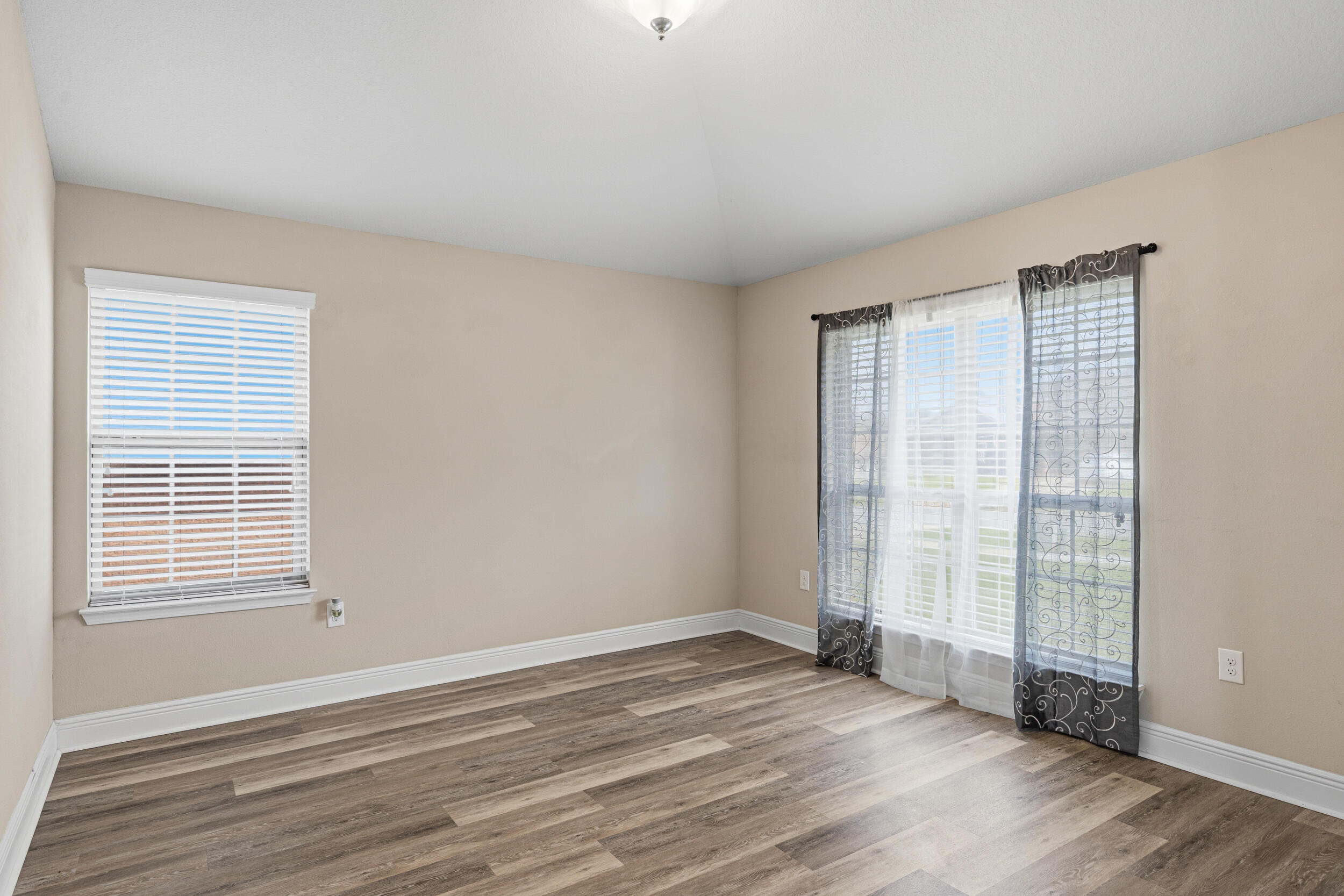 2345 Genevieve Way Crestview, FL 32536 - Photo 29 of 41 a view of an empty room with wooden floor and a window