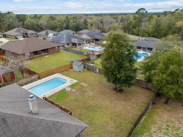 an aerial view of a house with a yard