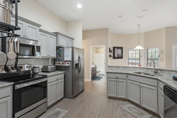 a kitchen with stainless steel appliances a sink stove and refrigerator