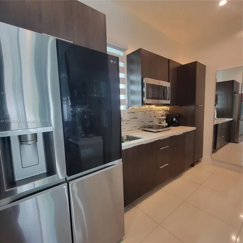 a kitchen with a refrigerator and a sink
