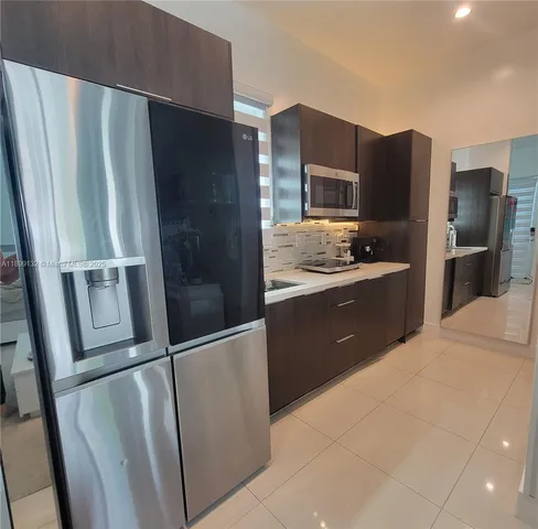 a kitchen with stainless steel appliances a refrigerator and a sink