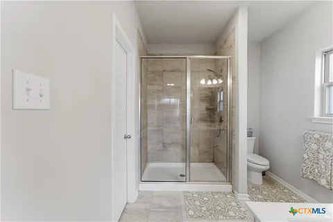 a bathroom with a shower and toilet