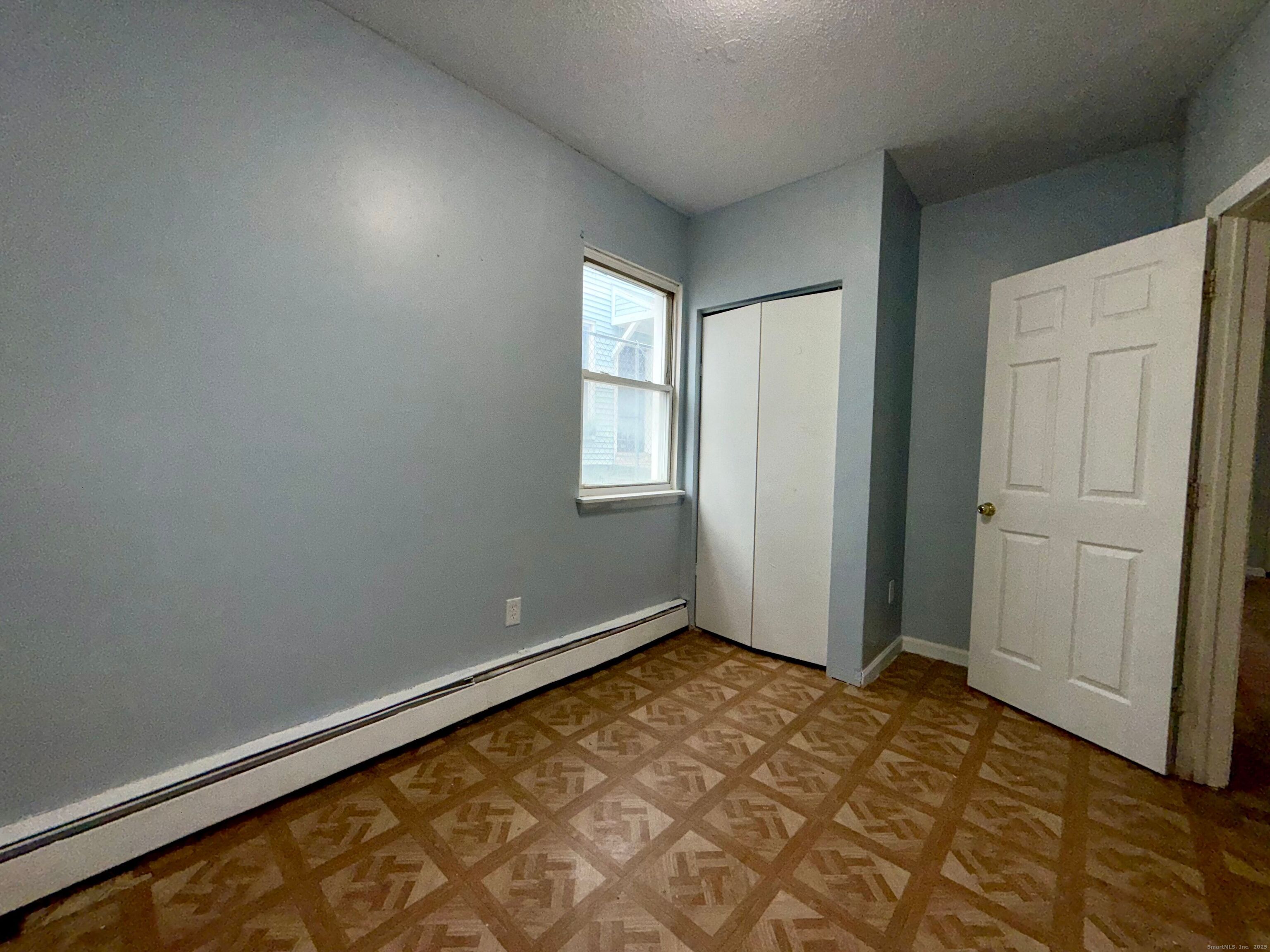 132 Locust Street, Unit 4 Waterbury, CT 06704 - Photo 7 of 8 an empty room with windows