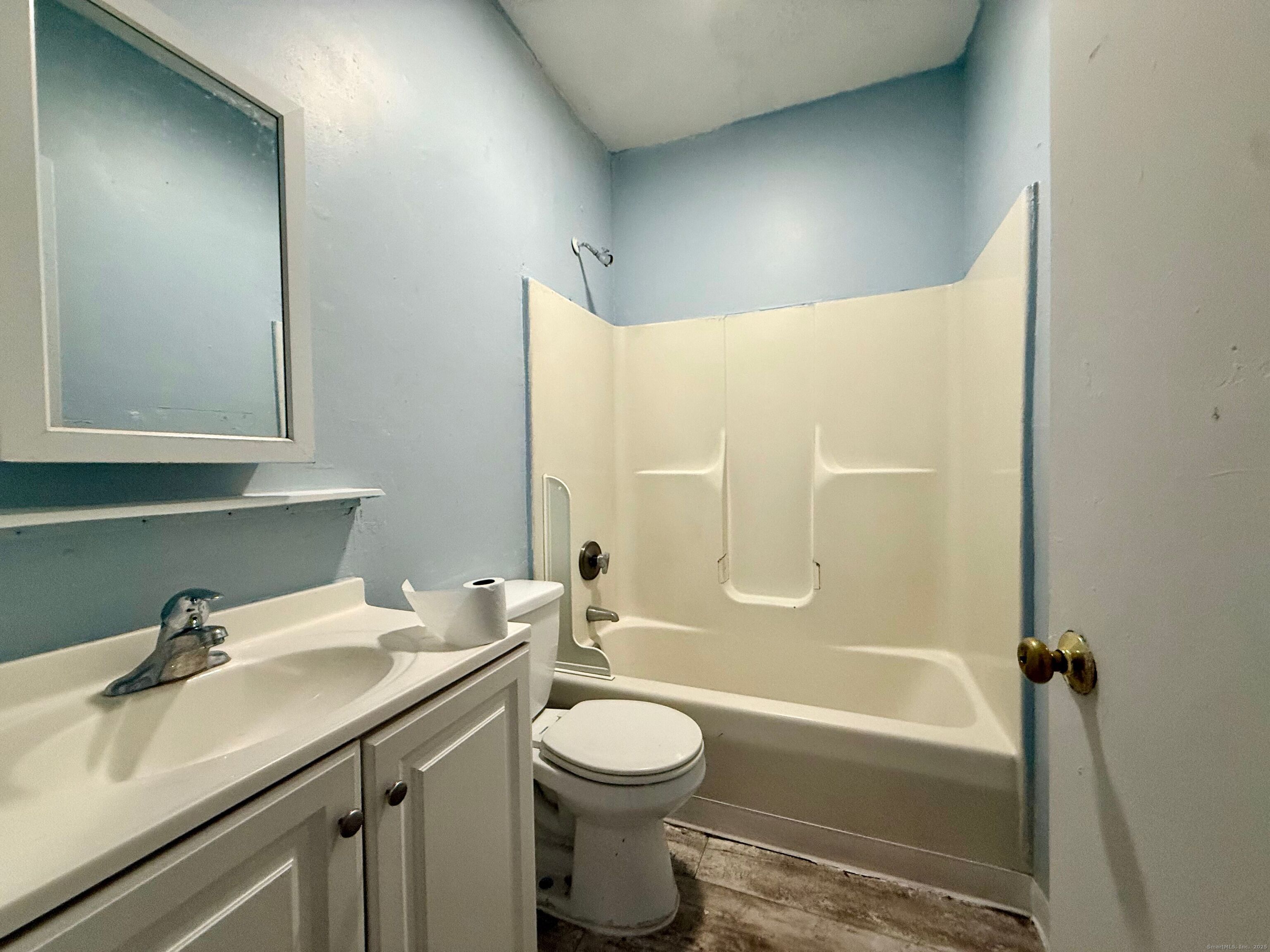 132 Locust Street, Unit 4 Waterbury, CT 06704 - Photo 8 of 8 a bathroom with a granite countertop sink toilet and shower