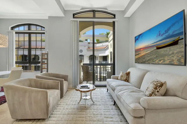 a living room with furniture and a floor to ceiling window