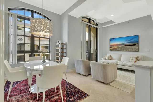 a living room with furniture a large window and a table