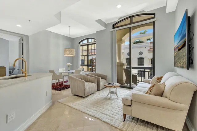 a living room with furniture a window and a flat screen tv